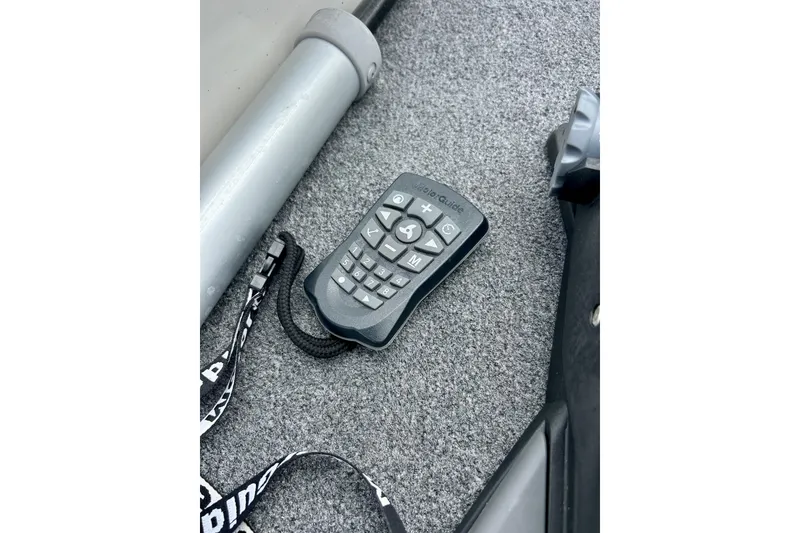 Slide: The Image of Remote control on carpeted floor of 1994 Stratos 290 Ski-N-Fish boat. - 18