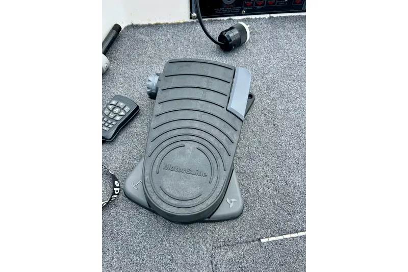 Slide: The Image of Foot pedal control on a 1994 Stratos 290 Ski-N-Fish boat carpeted floor. - 19