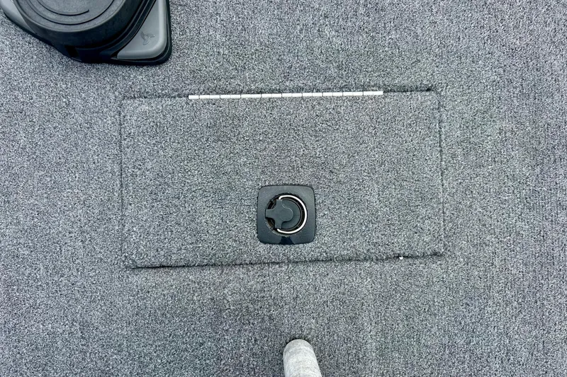 Slide: The Image of Carpeted deck of a 1994 Stratos 290 Ski-N-Fish boat with a hatch and latch. - 24