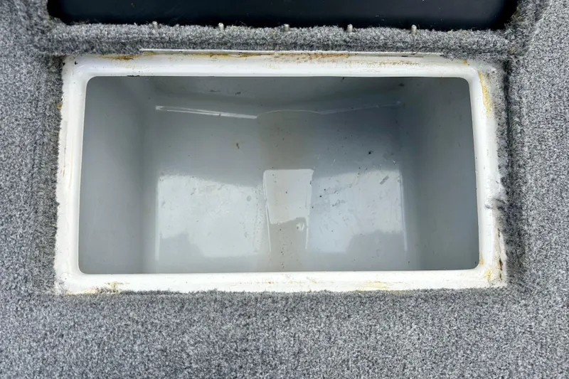 Slide: The Image of Empty storage compartment in 1994 Stratos 290 Ski-N-Fish boat, carpeted interior. - 25