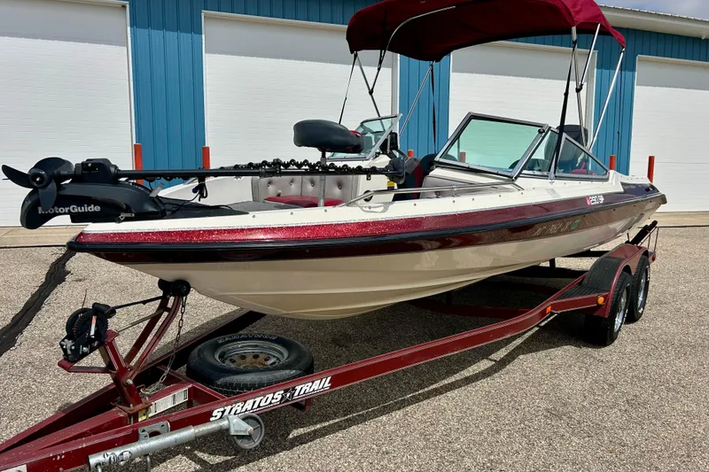 Slide: The Image of 1994 Stratos 290 Ski-N-Fish boat on trailer, featuring MotorGuide trolling motor. - 3