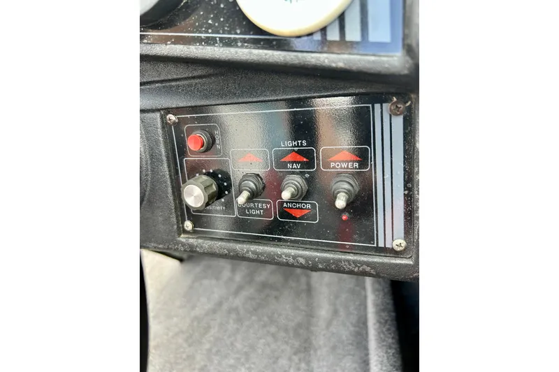 Slide: The Image of Control panel of a 1994 Stratos 290 Ski-N-Fish boat with switches and buttons. - 37