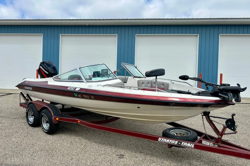 Slide: The Image of 1994 Stratos 290 Ski-N-Fish boat on trailer, parked near blue garage doors. - 4