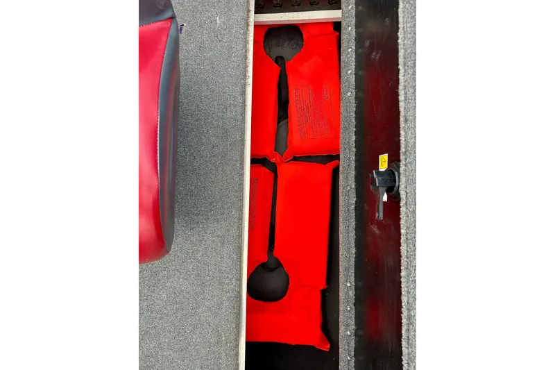 Slide: The Image of Storage compartment with red life jackets in a 1994 Stratos 290 Ski-N-Fish boat. - 42