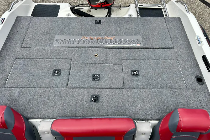 Slide: The Image of 1994 Stratos 290 Ski-N-Fish boat deck with storage compartments and red seats. - 43