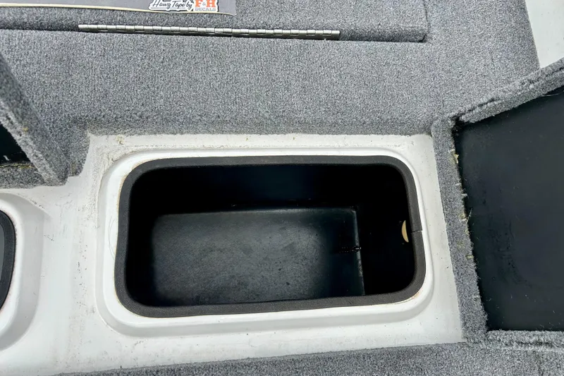 Slide: The Image of Storage compartment in 1994 Stratos 290 Ski-N-Fish boat, featuring carpeted interior. - 45