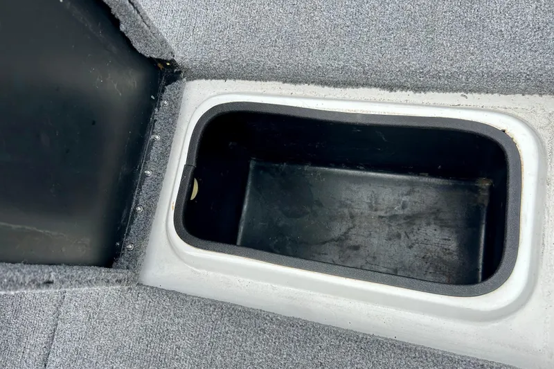 Slide: The Image of Storage compartment in 1994 Stratos 290 Ski-N-Fish boat, featuring carpeted interior. - 46