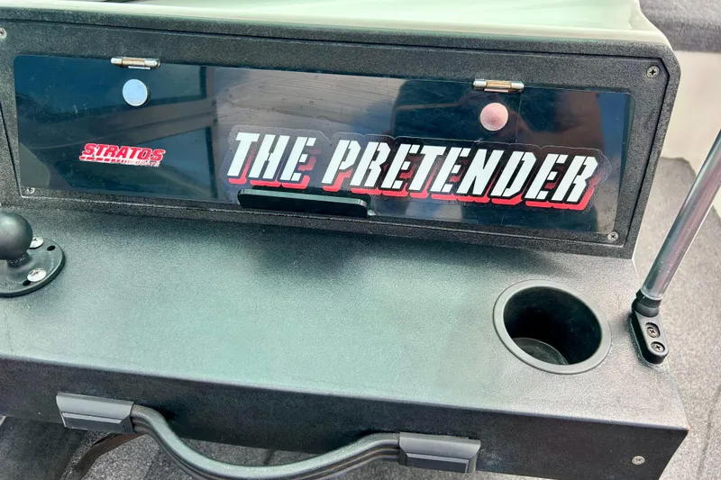 Slide: The Image of 1994 Stratos 290 Ski-N-Fish dashboard with "The Pretender" label and cup holder. - 49