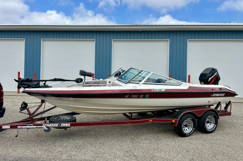Slide: The Image of 1994 Stratos 290 Ski-N-Fish boat on trailer, parked outside blue garage. - 5
