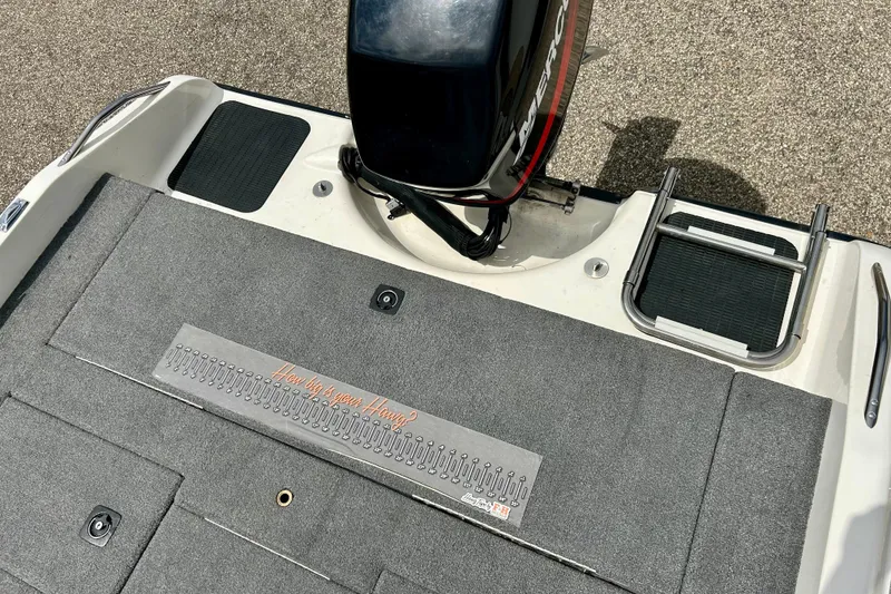 Slide: The Image of 1994 Stratos 290 Ski-N-Fish boat deck with motor and measuring ruler. - 53