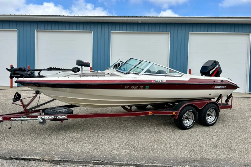 Slide: The Image of 1994 Stratos 290 Ski-N-Fish boat on trailer, parked outside blue garage. - 54