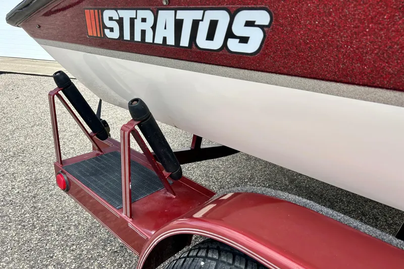 Slide: The Image of 1994 Stratos 290 Ski-N-Fish boat on red trailer, close-up view. - 6