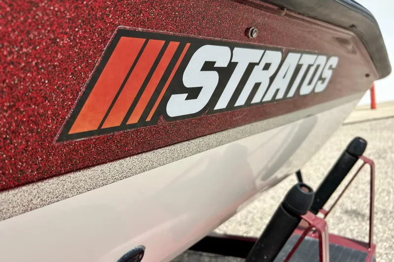 Slide: The Image of Close-up of 1994 Stratos 290 Ski-N-Fish boat logo on red hull. - 7