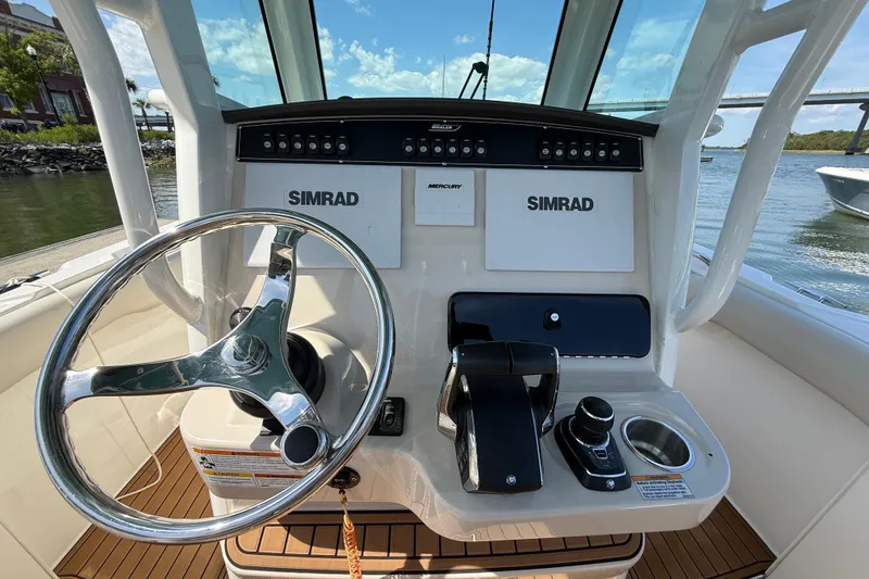 Slide: The Image of 2023 Boston Whaler 280 Outrage helm with Simrad electronics and Mercury controls. - 10