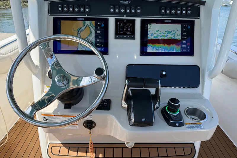 Slide: The Image of 2023 Boston Whaler 280 Outrage helm with advanced navigation displays and controls. - 11