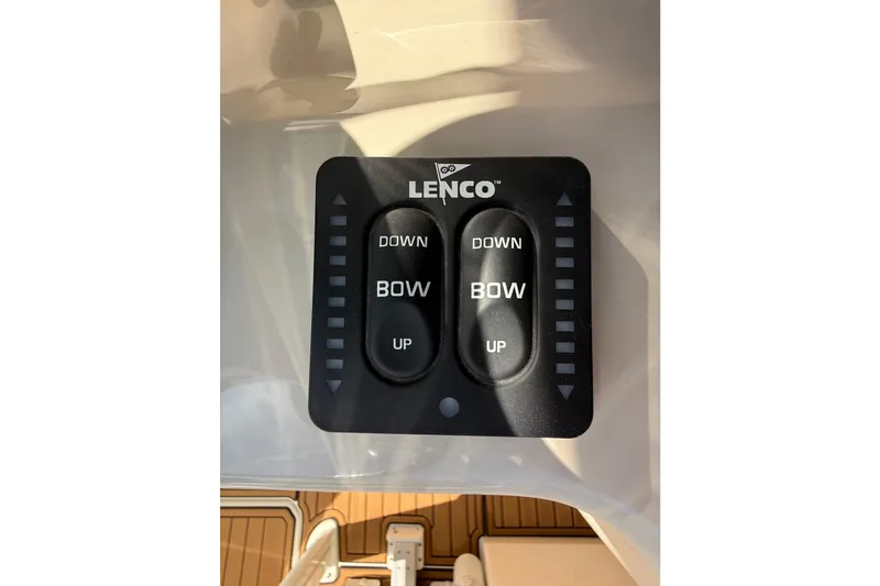 Slide: The Image of Lenco trim tab control panel on 2023 Boston Whaler 280 Outrage boat. - 19