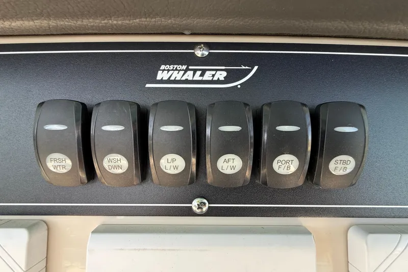Slide: The Image of Control panel of 2023 Boston Whaler 280 Outrage with labeled switches. - 22