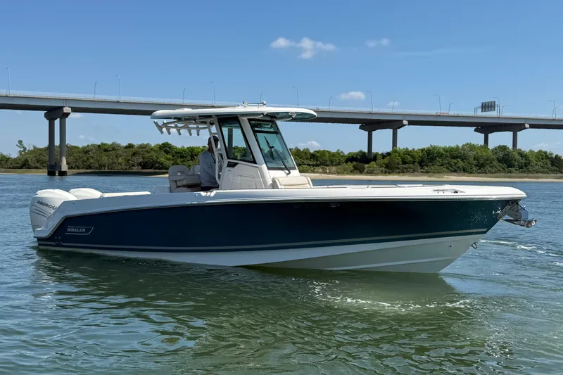 Slide: The Image of 2023 Boston Whaler 280 Outrage boat cruising on a sunny day near a bridge. - 3
