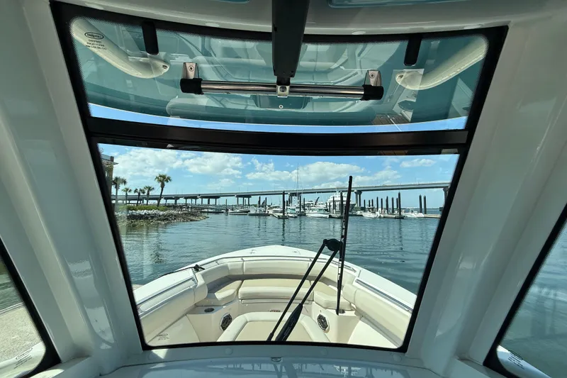 Slide: The Image of Interior view from a 2023 Boston Whaler 280 Outrage, overlooking a marina and bridge. - 35