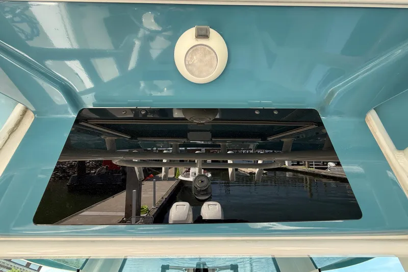 Slide: The Image of 2023 Boston Whaler 280 Outrage boat interior with blue finish and overhead light. - 36