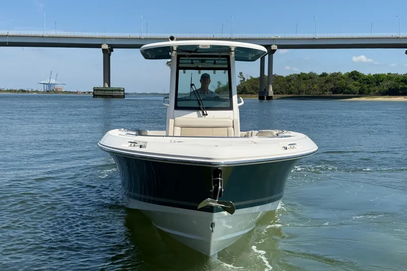 Slide: The Image of 2023 Boston Whaler 280 Outrage boat cruising under a bridge on a sunny day. - 4