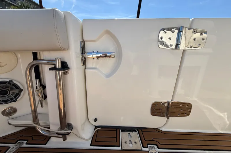 Slide: The Image of 2023 Boston Whaler 280 Outrage boat detail, featuring stainless steel hardware and teak flooring. - 42