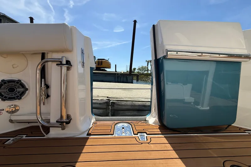 Slide: The Image of 2023 Boston Whaler 280 Outrage boat deck with stainless steel railing and speaker. - 43