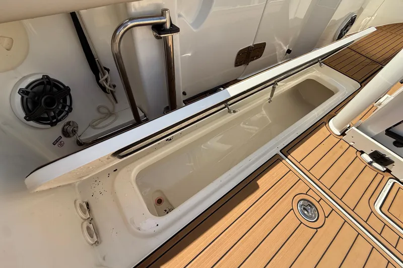 Slide: The Image of 2023 Boston Whaler 280 Outrage boat deck with open storage compartment and teak flooring. - 46
