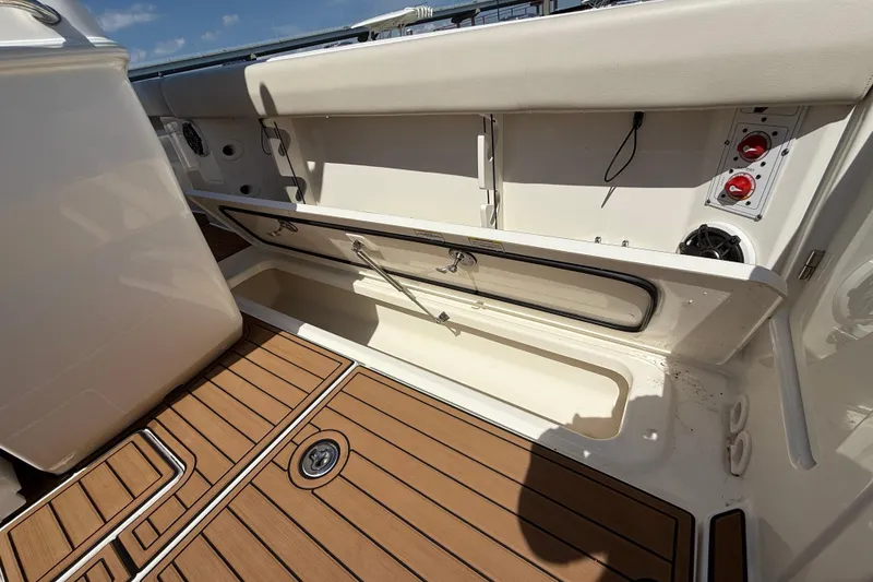 Slide: The Image of 2023 Boston Whaler 280 Outrage interior with open storage compartment and teak flooring. - 47