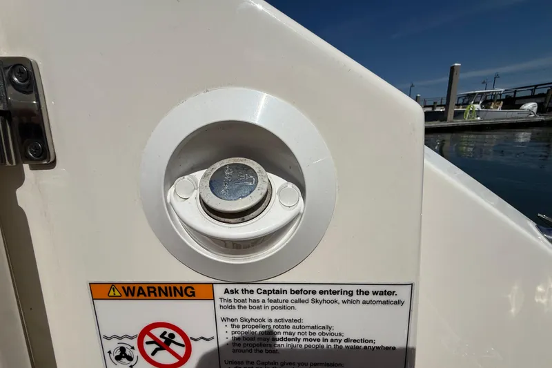 Slide: The Image of 2023 Boston Whaler 280 Outrage boat warning label and Skyhook feature control. - 51