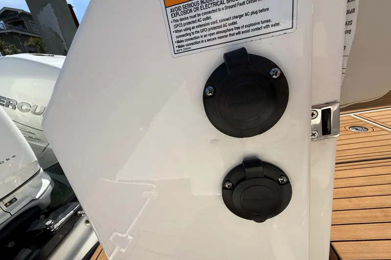 Slide: The Image of 2023 Boston Whaler 280 Outrage boat with electrical outlets and Mercury engine. - 52