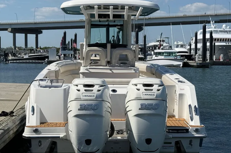 Slide: The Image of 2023 Boston Whaler 280 Outrage boat with dual 350 Verado engines docked at marina. - 6