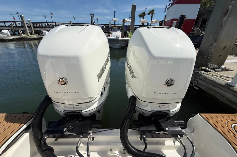 Slide: The Image of Twin Mercury FourStroke engines on a 2023 Boston Whaler 280 Outrage at the dock. - 7
