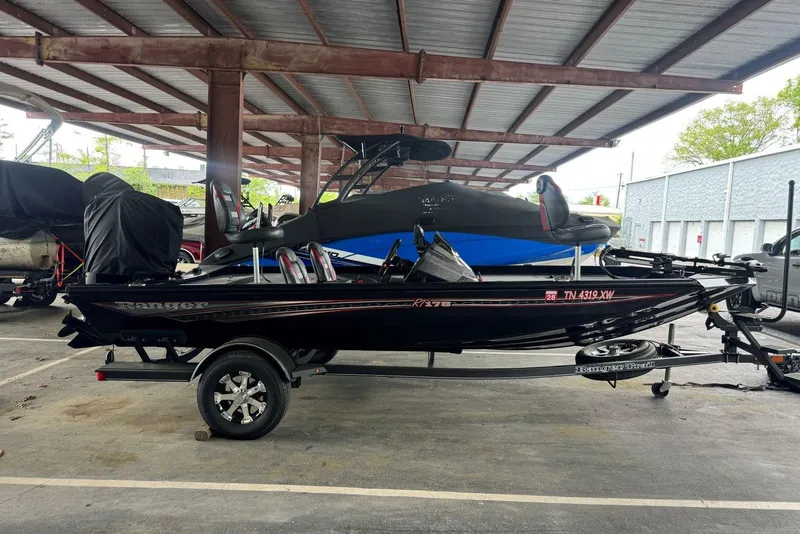 Slide: The Image of 2021 Ranger RT178 boat parked under a metal canopy in a storage area. - 10