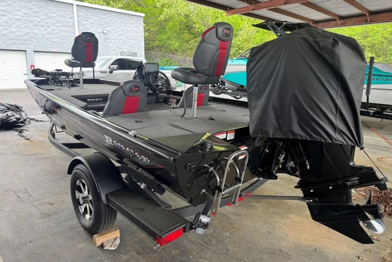 Slide: The Image of 2021 Ranger RT178 fishing boat with covered motor, parked under a shelter. - 13