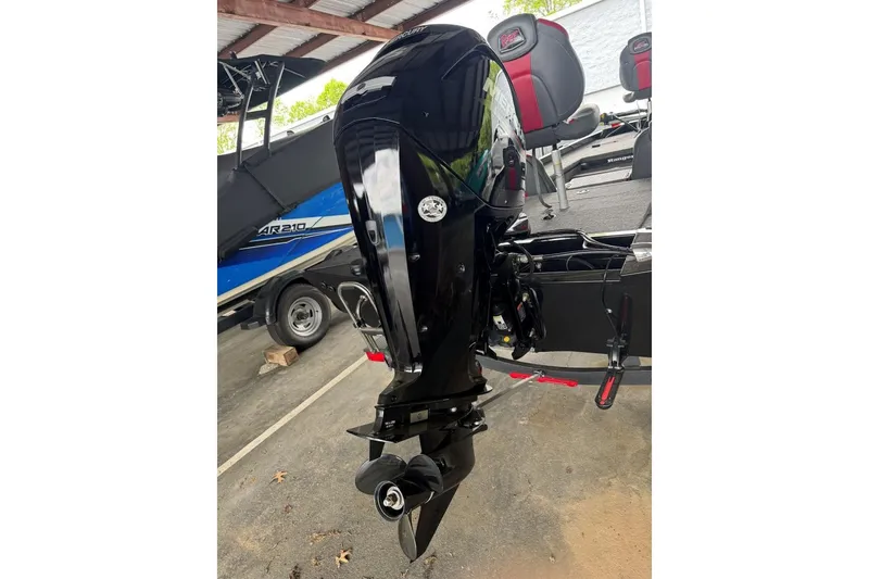 Slide: The Image of 2021 Ranger RT178 boat with a sleek black outboard motor in a covered storage area. - 16