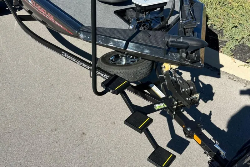 Slide: The Image of 2021 Ranger RT178 boat trailer with winch and steps on pavement. - 17