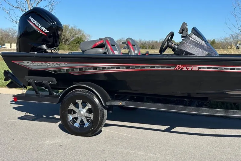 Slide: The Image of 2021 Ranger RT178 boat with Mercury engine on trailer, parked outdoors. - 2