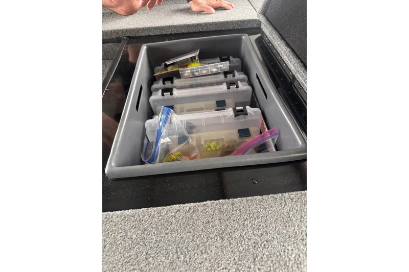 Slide: The Image of Storage compartment in a 2021 Ranger RT178 boat with organized fishing tackle boxes. - 24