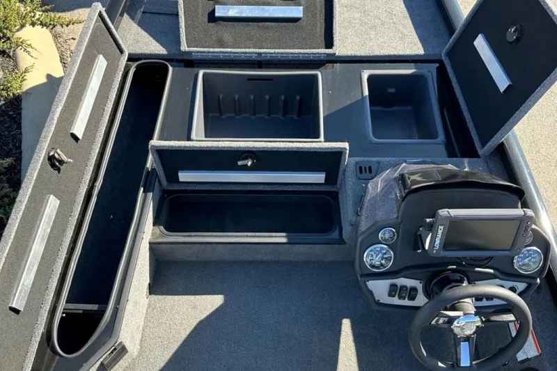 Slide: The Image of 2021 Ranger RT178 boat interior with storage compartments and steering console. - 31