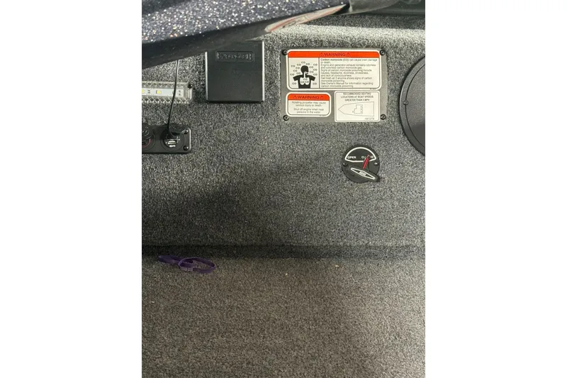 Slide: The Image of 2021 Ranger RT178 boat interior with warning labels and control panel. - 39