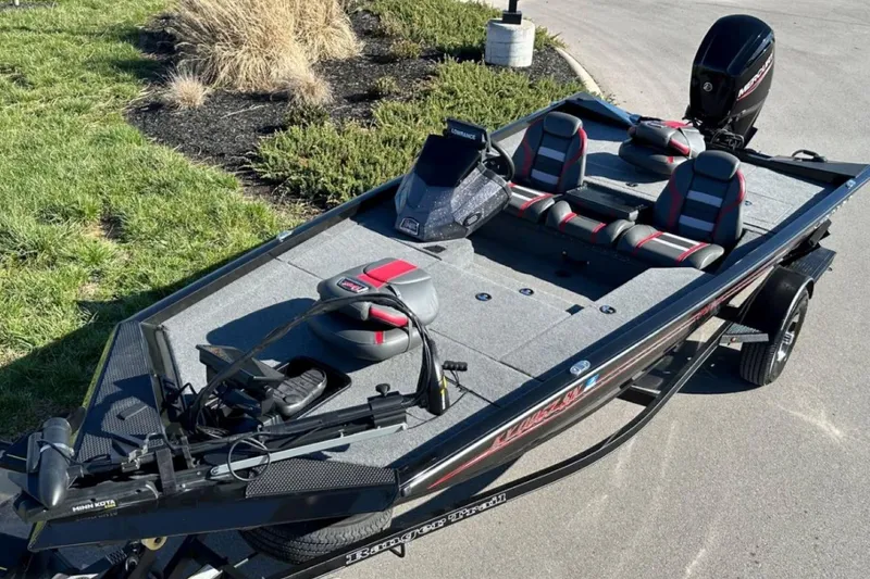 Slide: The Image of 2021 Ranger RT178 fishing boat with seating and motor, parked on pavement. - 4