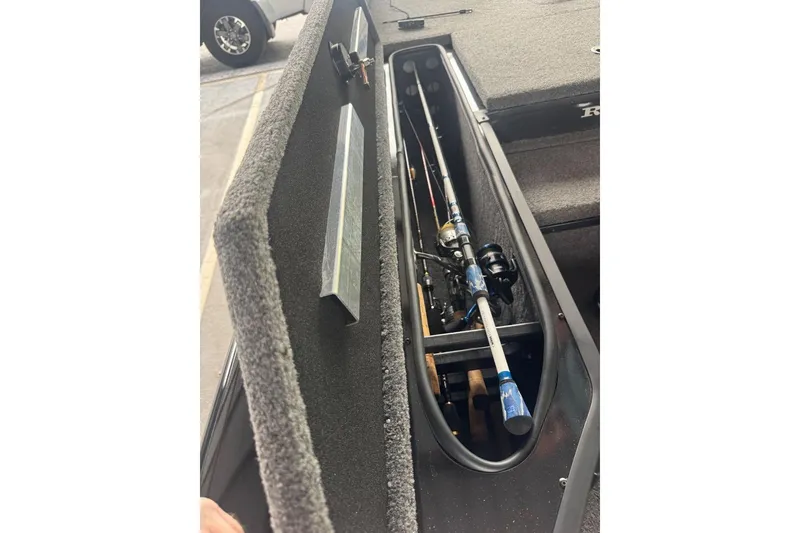 Slide: The Image of 2021 Ranger RT178 boat storage compartment with fishing rods inside. - 41