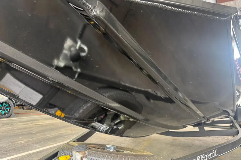 Slide: The Image of 2021 Ranger RT178 boat hull on trailer, showcasing sleek black finish. - 44