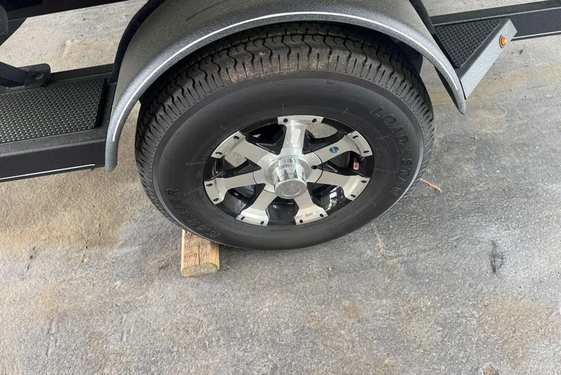 Slide: The Image of 2021 Ranger RT178 trailer wheel on wooden block, featuring Load Star tire. - 47