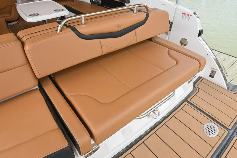 Slide: The Image of 2022 Chaparral 307 SSX boat with tan leather seating and swim platform. - 11