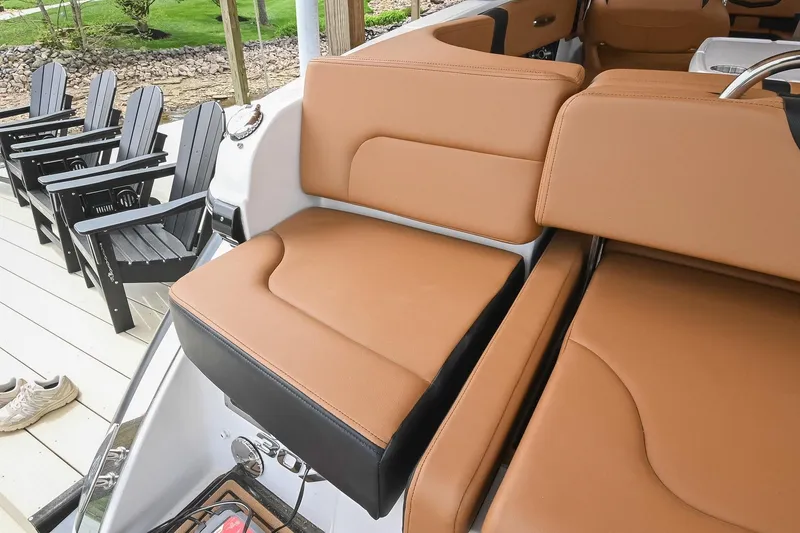 Slide: The Image of Luxurious tan seating on 2022 Chaparral 307 SSX boat, with black chairs in background. - 12