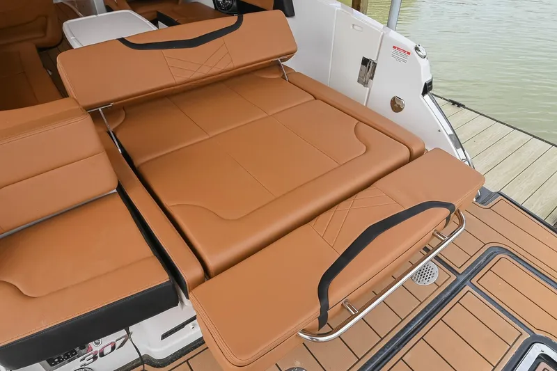 Slide: The Image of 2022 Chaparral 307 SSX boat with luxurious tan leather seating and sleek design. - 13
