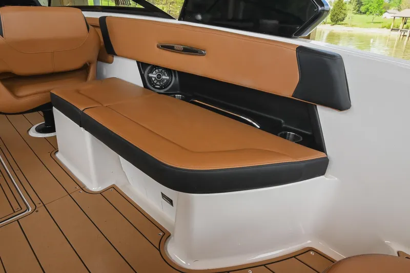 Slide: The Image of Luxurious interior seating of 2022 Chaparral 307 SSX boat with tan and black upholstery. - 16