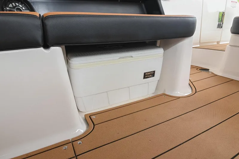 Slide: The Image of 2022 Chaparral 307 SSX boat interior with Igloo cooler storage under seating. - 18